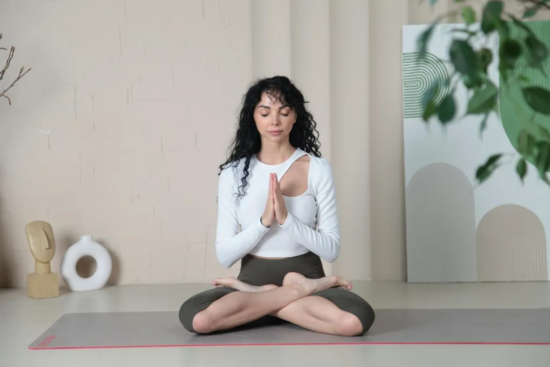Frau in Yoga-Sitzhaltung mit geschlossenen Augen – Yogi-Atmung als fließende Atemwelle